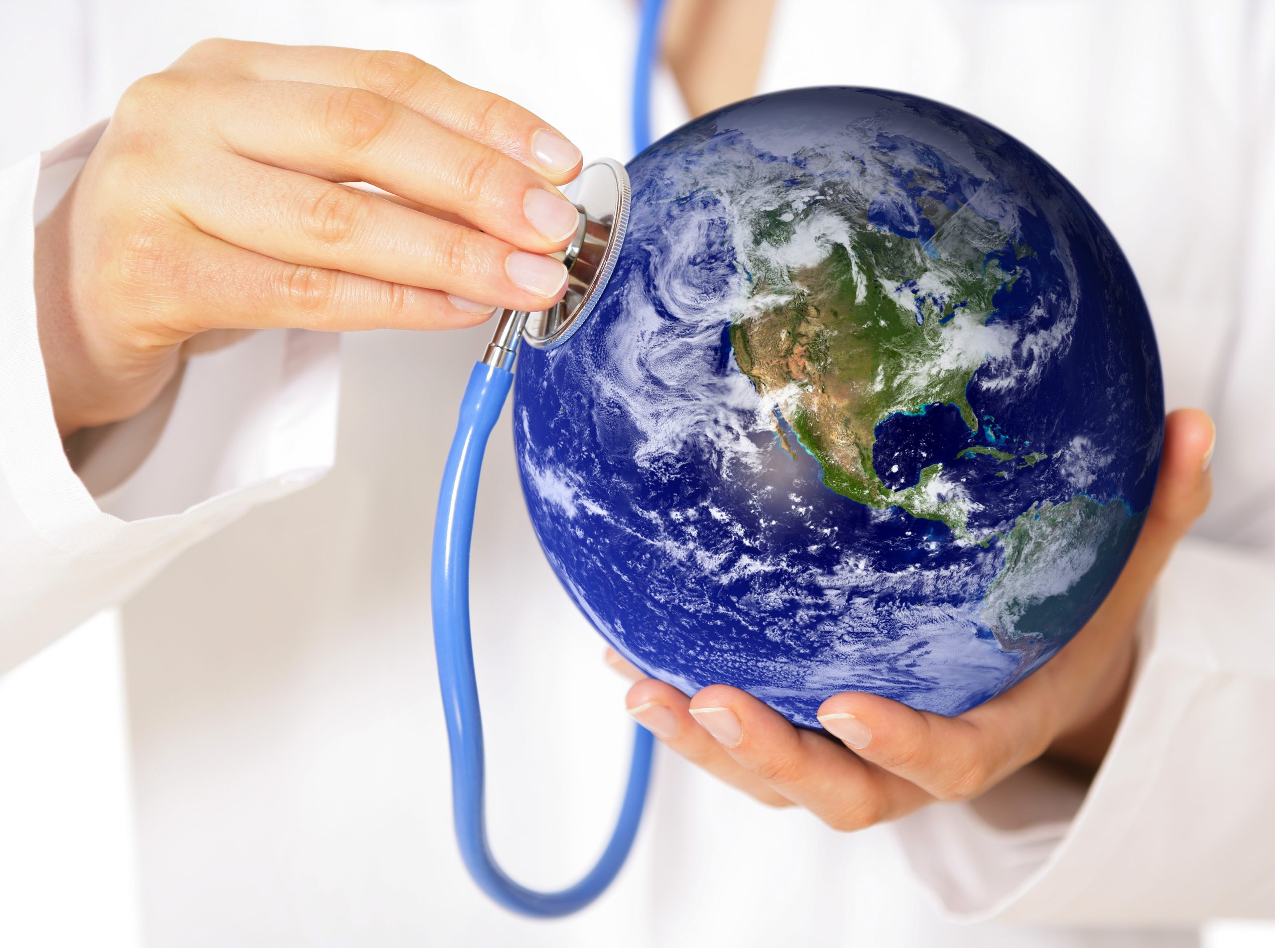 nurse in white coat holding a stethoscope to a globe