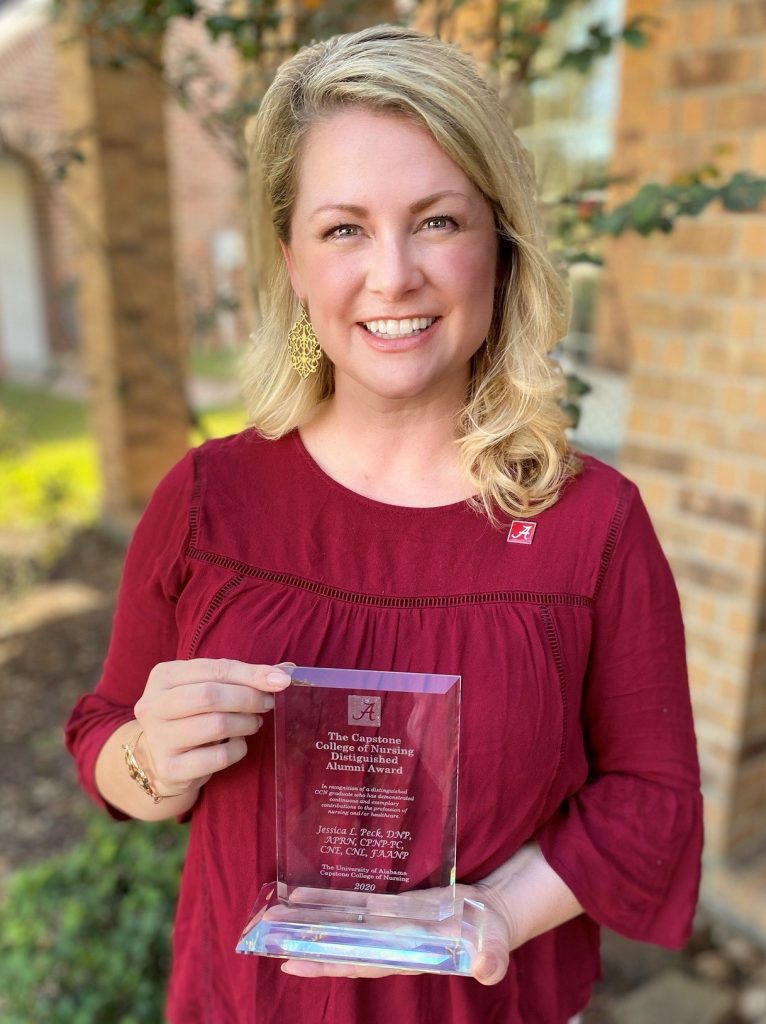 Dr. Jessica Peck holding award