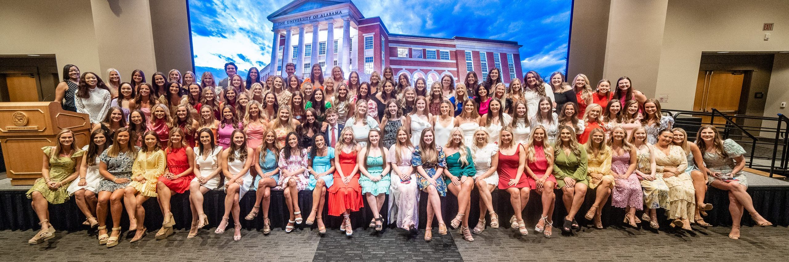 Group of students gathered for photo on stage