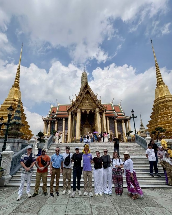Students standing in front of Thailand building