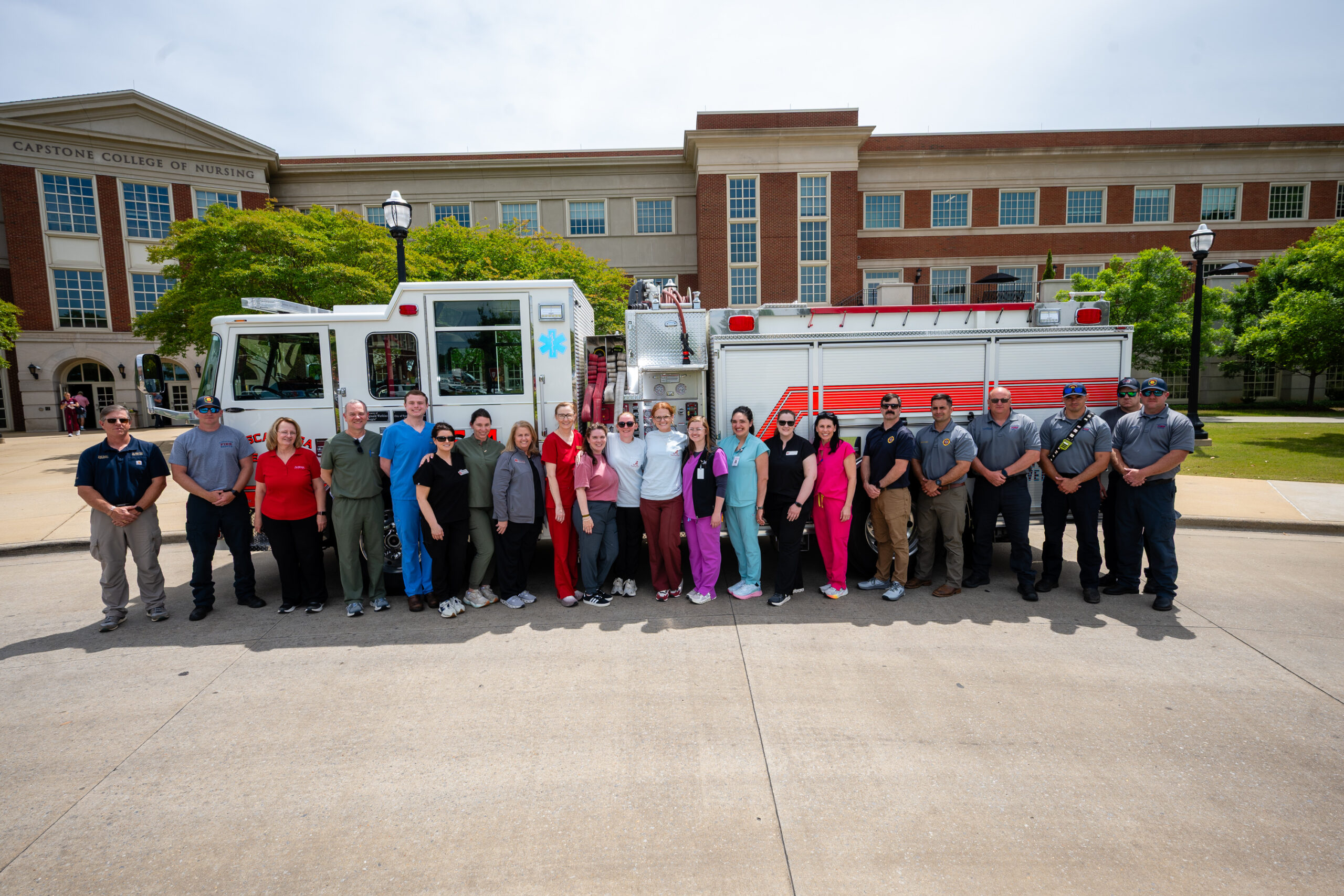 Image of interprofessional team in front of fire truck